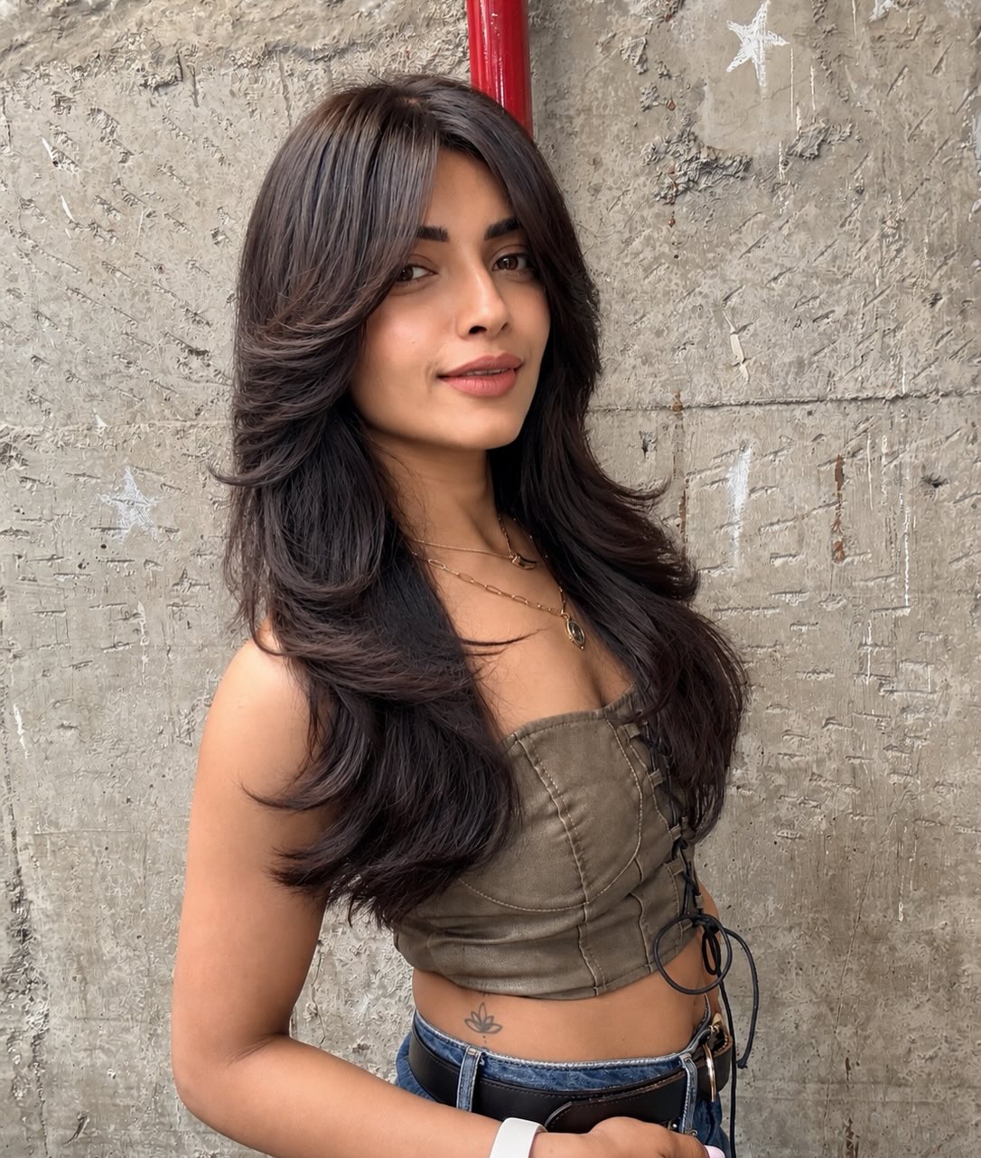 A glossy, layered brunette blow-dry by Salon Muah