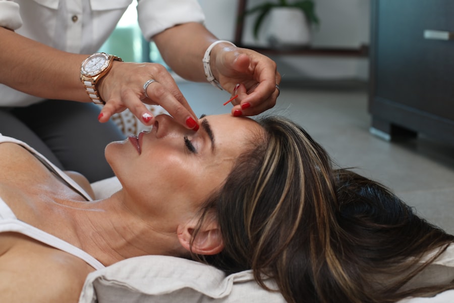 A facial in progress, practised hands smoothing serum at the brow.